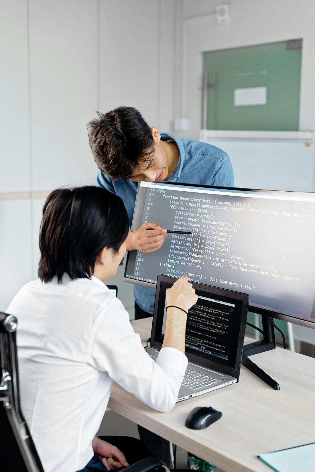 Two Sigmaschool students pair-programming at a laptop during a live Buildroom session